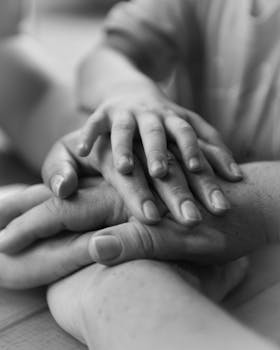A touching black and white photo of hands conveying family unity and love.