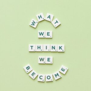 Motivational quote arranged with letter tiles on a light green background.